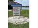 Community park with regulations sign posted, overlooking a serene lake at 724 Rosemere Cir, Orlando, FL 32835