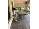 Relaxing screened porch with tile flooring, glass table, and decorative sun shades at 724 Rosemere Cir, Orlando, FL 32835