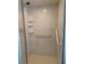 Clean shower with neutral colored tile, safety bars, and a glass door at 724 Rosemere Cir, Orlando, FL 32835