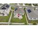 Aerial view featuring a well-manicured backyard with a patio, a red umbrella, and lush green lawn at 733 Citrus Reserve Blvd, Davenport, FL 33837