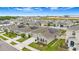 Aerial shot of a neighborhood with homes featuring solar panels and landscaped yards at 733 Citrus Reserve Blvd, Davenport, FL 33837