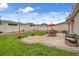 Large backyard with well-maintained lawn, patio with outdoor dining set, and string lights at 733 Citrus Reserve Blvd, Davenport, FL 33837