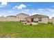 Spacious backyard with a brick patio, dining set, and lush green grass, perfect for entertaining at 733 Citrus Reserve Blvd, Davenport, FL 33837