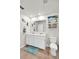 Bright bathroom featuring double sinks, a large mirror, a white toilet, and coastal-themed decor at 733 Citrus Reserve Blvd, Davenport, FL 33837