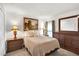 Comfortable bedroom with a tan bed, warm lamps, and a window that provides natural light at 733 Citrus Reserve Blvd, Davenport, FL 33837