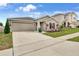 Inviting home exterior showcasing a two-car garage and a beautifully landscaped front yard at 733 Citrus Reserve Blvd, Davenport, FL 33837