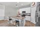 Kitchen with white cabinets, center island with seating, and modern stainless steel appliances at 733 Citrus Reserve Blvd, Davenport, FL 33837