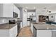 Modern kitchen with white cabinets, stainless steel appliances, and center island with bar seating at 733 Citrus Reserve Blvd, Davenport, FL 33837