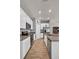 Well-lit kitchen features modern appliances and white cabinetry, with an open view to the living area at 733 Citrus Reserve Blvd, Davenport, FL 33837