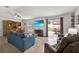 Cozy living room with large sliding doors to patio, TV above fireplace, and open dining area at 733 Citrus Reserve Blvd, Davenport, FL 33837