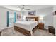 Relaxing main bedroom featuring coastal decor, a ceiling fan, and a comfortable king-sized bed at 733 Citrus Reserve Blvd, Davenport, FL 33837