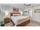 Comfortable bedroom boasts a king-sized bed, neutral colors, ceiling fan, and calming beach-themed decor at 733 Citrus Reserve Blvd, Davenport, FL 33837