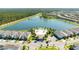 Panoramic aerial view of homes surrounding a lake with community pool and facilities at 8800 Corcovado Dr, Kissimmee, FL 34747