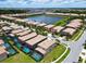 Aerial view of homes surrounding a tranquil lake, creating a serene community ambiance at 8800 Corcovado Dr, Kissimmee, FL 34747