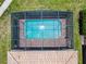 Aerial view of a screened-in backyard pool, patio, and landscaped yard at 8800 Corcovado Dr, Kissimmee, FL 34747