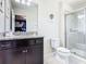 Bathroom with granite countertops, dark wood vanity and a glass shower provides convenience at 8800 Corcovado Dr, Kissimmee, FL 34747
