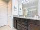 Bathroom with a double sink vanity with granite countertops, and a glass enclosed shower at 8800 Corcovado Dr, Kissimmee, FL 34747