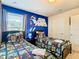 The Star Wars-themed bedroom features two twin beds with comic-themed bedding and a wall decal at 8800 Corcovado Dr, Kissimmee, FL 34747