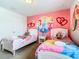 Charming bedroom featuring twin beds, Disney Princess wall art, and cozy decor for a magical stay at 8800 Corcovado Dr, Kissimmee, FL 34747