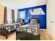 Stylish Star Wars themed bedroom features two twin beds, themed bedding, and a bright blue accent wall at 8800 Corcovado Dr, Kissimmee, FL 34747