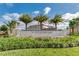 Windsor at Westside community entrance features lush landscaping, palm trees, and a decorative water feature sign at 8800 Corcovado Dr, Kissimmee, FL 34747