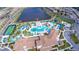 Overhead view of a resort-style pool with lazy river, playground, and lakeside clubhouse at 8800 Corcovado Dr, Kissimmee, FL 34747