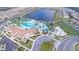 Aerial view showcasing a resort-style pool, playground, and clubhouse by a serene lake at 8800 Corcovado Dr, Kissimmee, FL 34747
