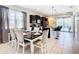 Open-concept dining area flowing into a modern kitchen with a breakfast bar at 8800 Corcovado Dr, Kissimmee, FL 34747