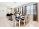 Formal dining area adjacent to a living room, featuring neutral tones at 8800 Corcovado Dr, Kissimmee, FL 34747