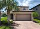 Charming two-story home with a brick driveway and a two car garage at 8800 Corcovado Dr, Kissimmee, FL 34747