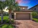 Beautiful two-story home with a brick driveway and well-maintained landscaping at 8800 Corcovado Dr, Kissimmee, FL 34747