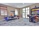 Fun game room featuring an air hockey table, arcade games, and modern flooring at 8800 Corcovado Dr, Kissimmee, FL 34747