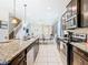 Open kitchen featuring granite countertops, stainless steel appliances, and a view of the dining area at 8800 Corcovado Dr, Kissimmee, FL 34747