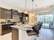 Modern kitchen featuring dark cabinets, granite countertops, and stainless appliances at 8800 Corcovado Dr, Kissimmee, FL 34747