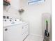 Well-equipped laundry room with washer, dryer, shelving and natural light at 8800 Corcovado Dr, Kissimmee, FL 34747