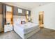 Spacious main bedroom featuring a king bed, carpet floors, and an ensuite bathroom at 8800 Corcovado Dr, Kissimmee, FL 34747
