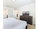 Bedroom with a king bed, television, a dresser with drawers and an en-suite bath view at 8800 Corcovado Dr, Kissimmee, FL 34747