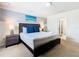 Comfortable main bedroom with a king bed, stylish decor, bedside tables, and a view into the en-suite bath at 8800 Corcovado Dr, Kissimmee, FL 34747