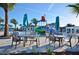 Resort-style pool area featuring comfortable seating, umbrellas, and a splash pad at 8800 Corcovado Dr, Kissimmee, FL 34747