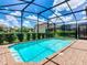 Backyard pool is fenced in and surrounded by patio at 8800 Corcovado Dr, Kissimmee, FL 34747