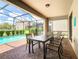 Outdoor dining on the screened patio, by the pool at 8800 Corcovado Dr, Kissimmee, FL 34747