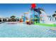 View of a water park with colorful slides, water features, and poolside seating for Gathering fun at 8800 Corcovado Dr, Kissimmee, FL 34747