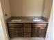 Bathroom vanity with double sinks, dark wood cabinets, and granite countertop, offering plenty of space and style at 891 Cr 482C, Lake Panasoffkee, FL 33538