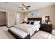 Inviting main bedroom with plush bedding, a ceiling fan, and soft lighting, creating a relaxing retreat at 891 Cr 482C, Lake Panasoffkee, FL 33538