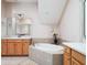 Bright bathroom with a soaking tub, double sinks, and vanity lighting at 9335 San Jose Blvd, Howey In The Hills, FL 34737