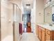 Hallway bathroom featuring a glass shower and vanity at 9335 San Jose Blvd, Howey In The Hills, FL 34737