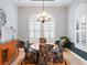 Bright dining room with a chandelier, shuttered windows and neutral wall paint at 9335 San Jose Blvd, Howey In The Hills, FL 34737