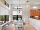 Bright dining room with large windows, pendant lighting, and table with seating at 9335 San Jose Blvd, Howey In The Hills, FL 34737