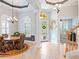 Welcoming foyer with tile flooring, arched windows and a charming chandelier at 9335 San Jose Blvd, Howey In The Hills, FL 34737