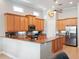 Open kitchen design with granite countertops, wood cabinets, and stainless steel appliances at 9335 San Jose Blvd, Howey In The Hills, FL 34737